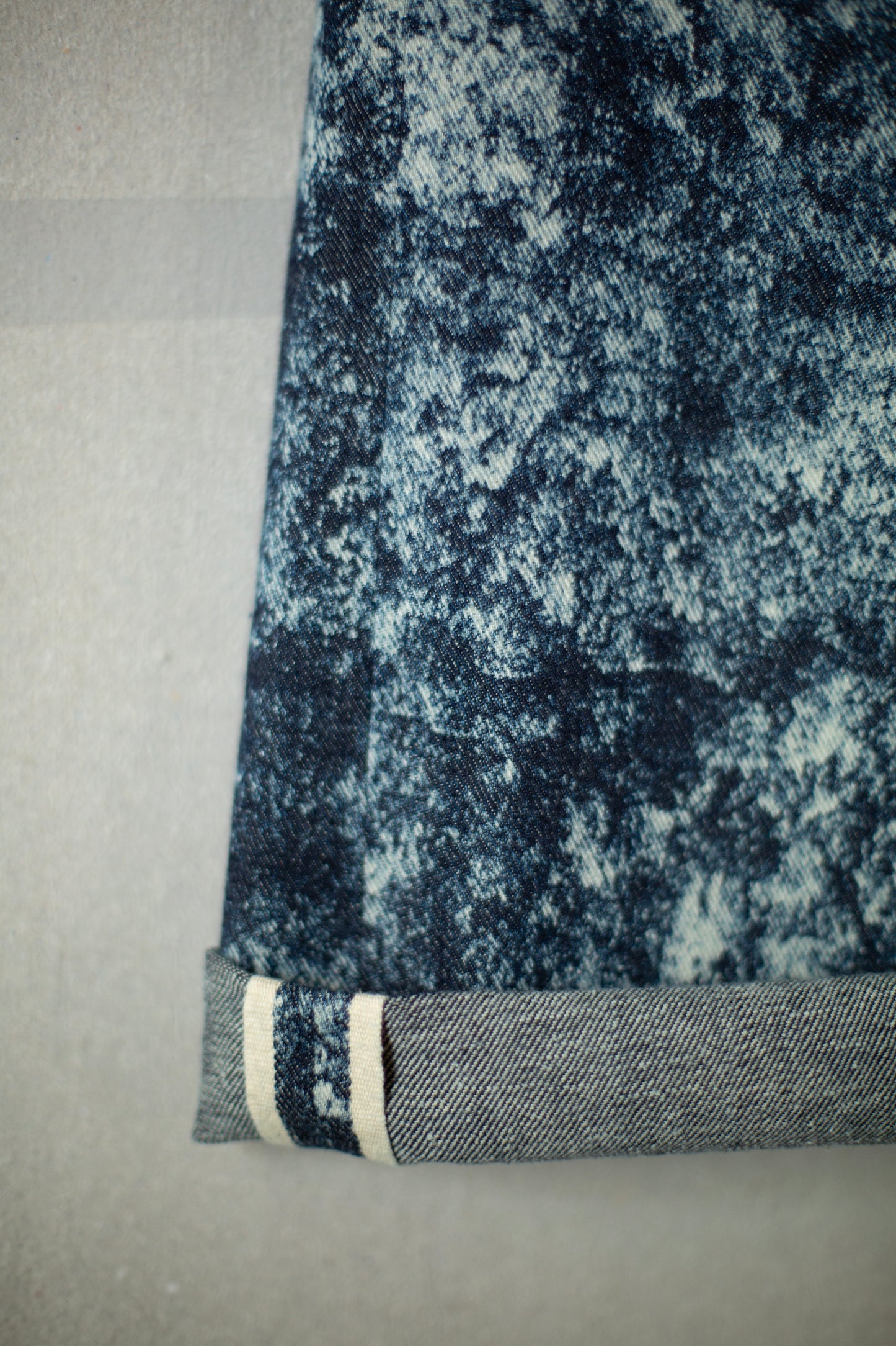 Discharged indigo denim trousers