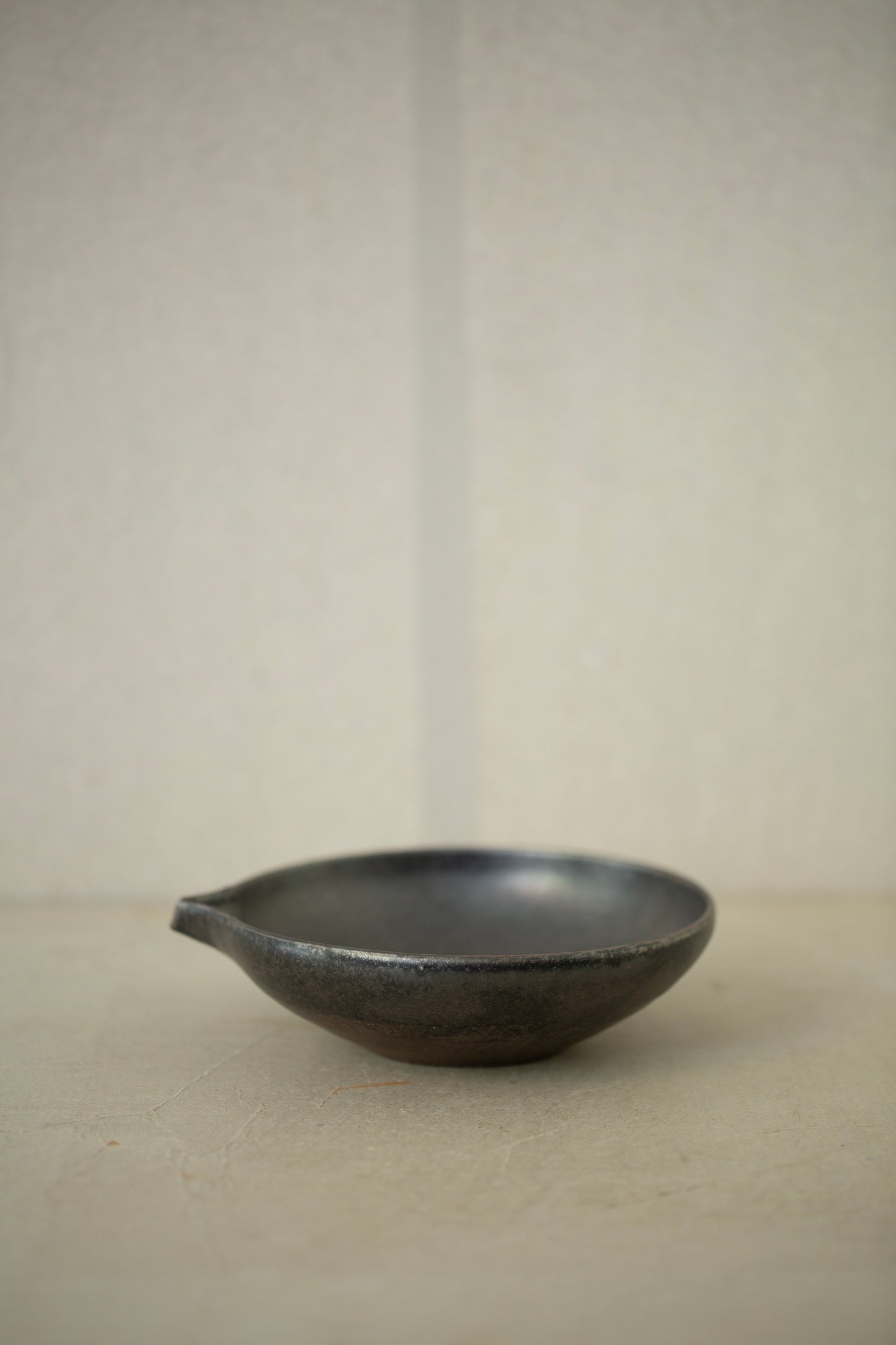 Ceramic sake pourer + saucer by Yohji Matsumiya