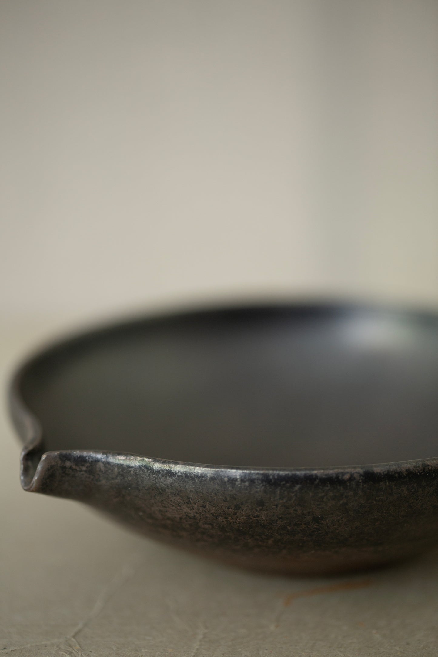 Ceramic sake pourer + saucer by Yohji Matsumiya