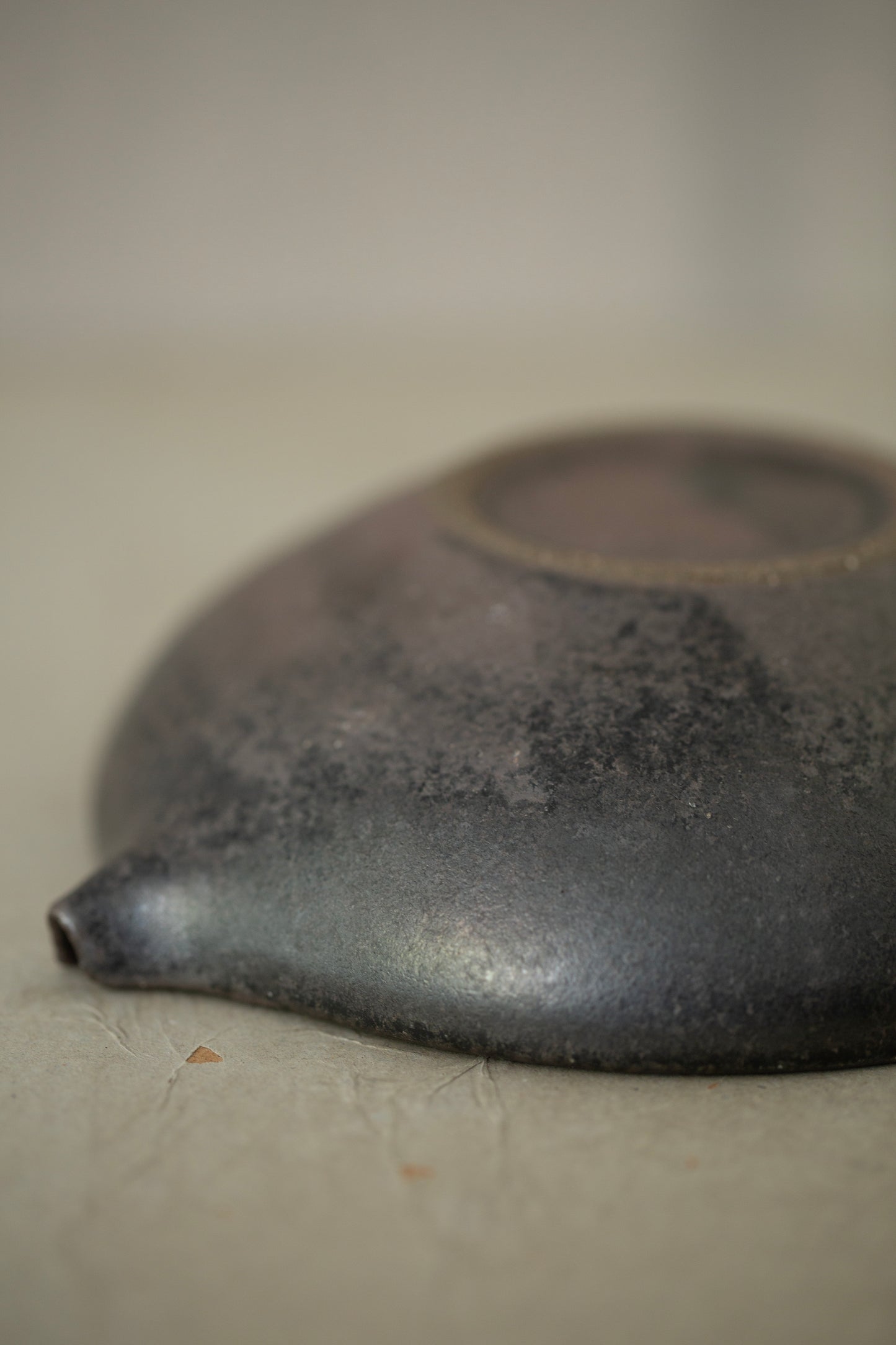 Ceramic sake pourer + saucer by Yohji Matsumiya