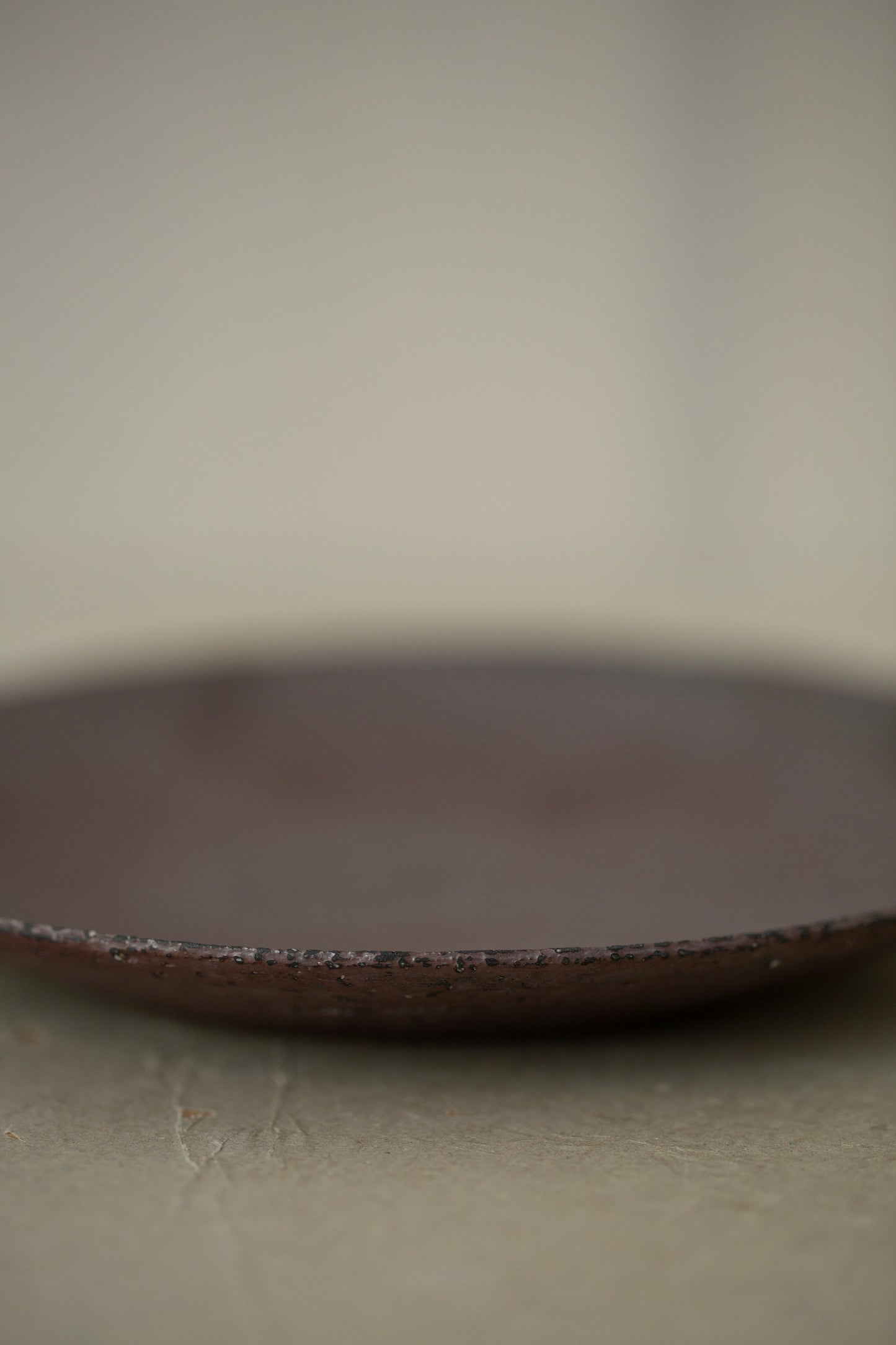 Ceramic sake pourer + saucer by Yohji Matsumiya