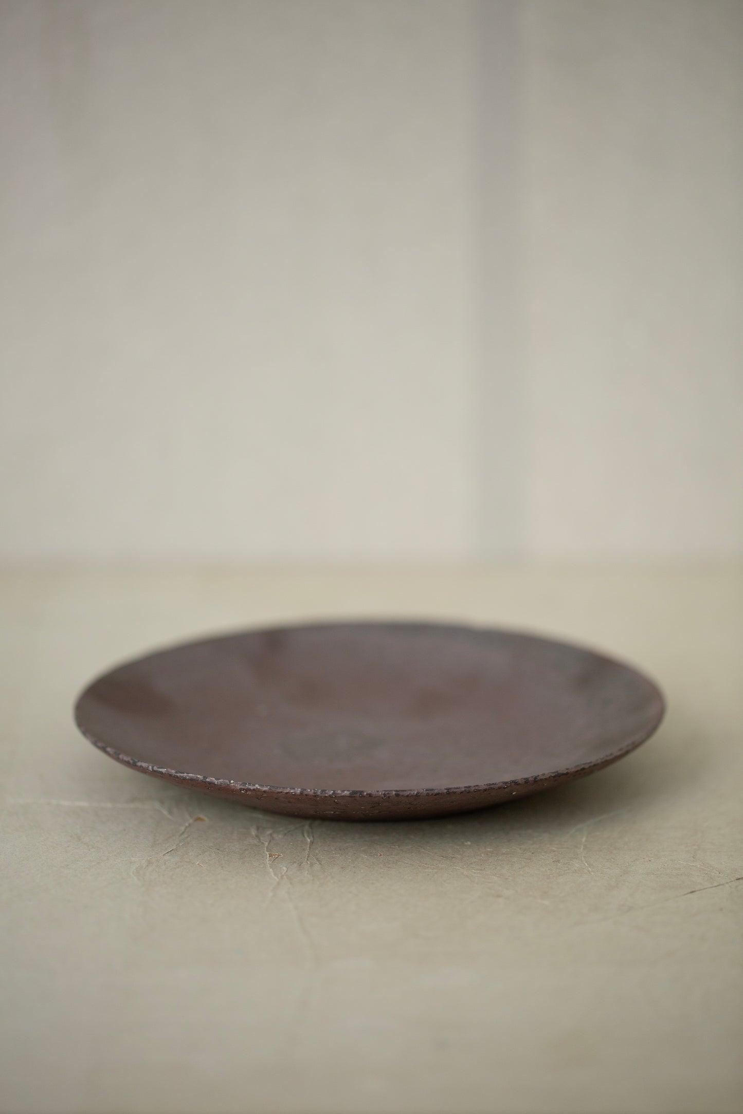 Ceramic sake pourer + saucer by Yohji Matsumiya
