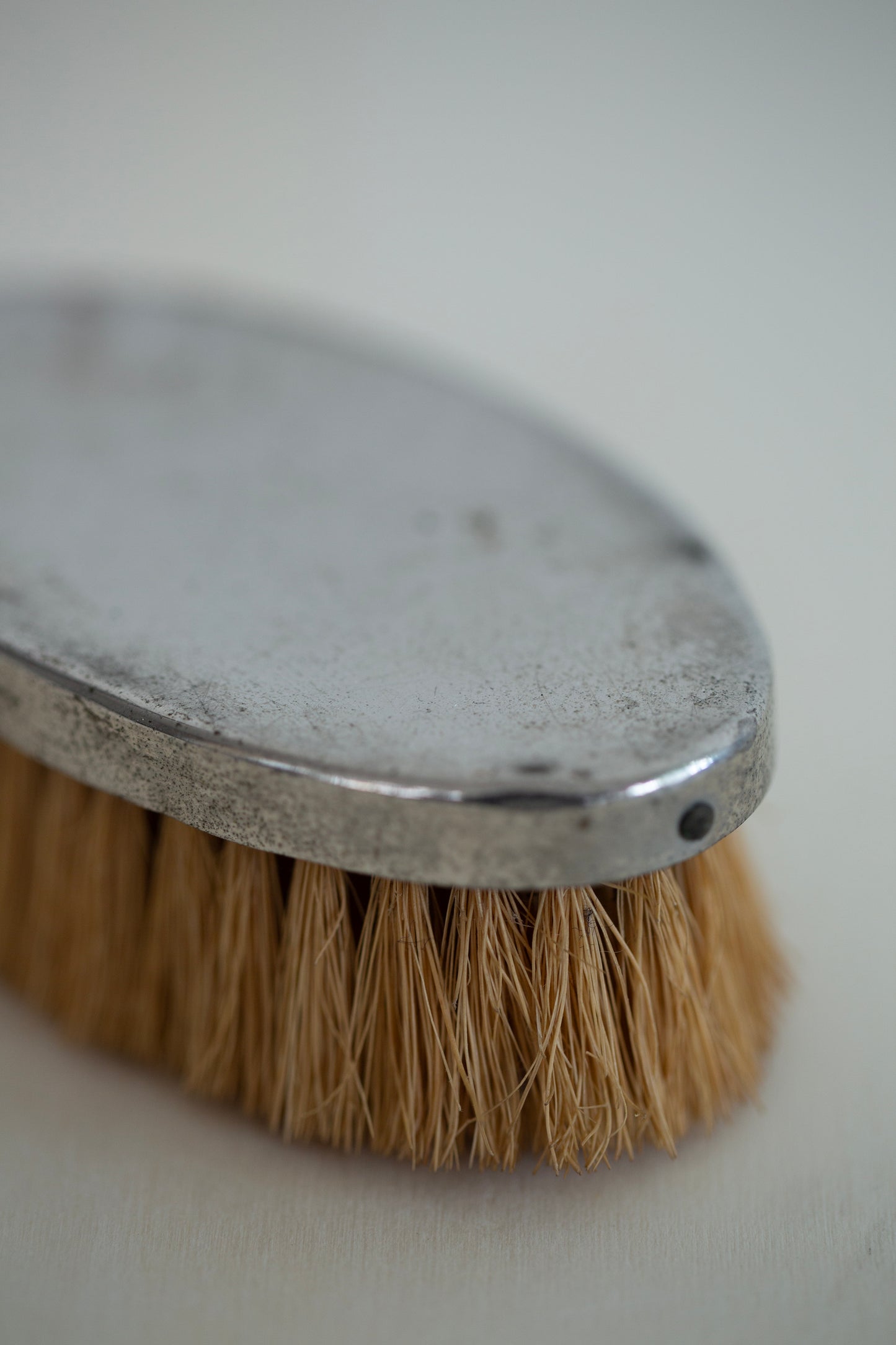 small brush with metal cover