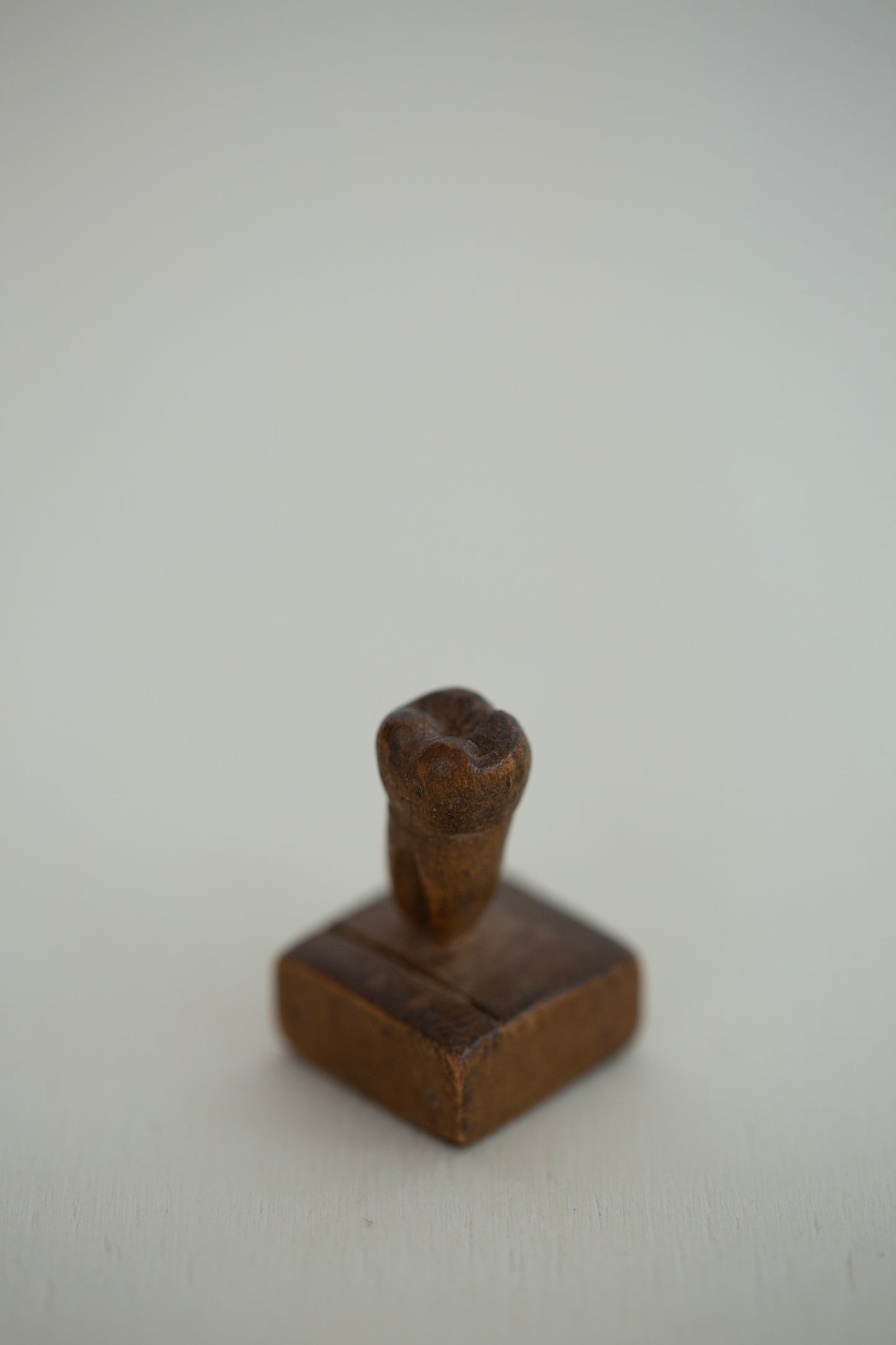 small sculpture woodcarved human tooth