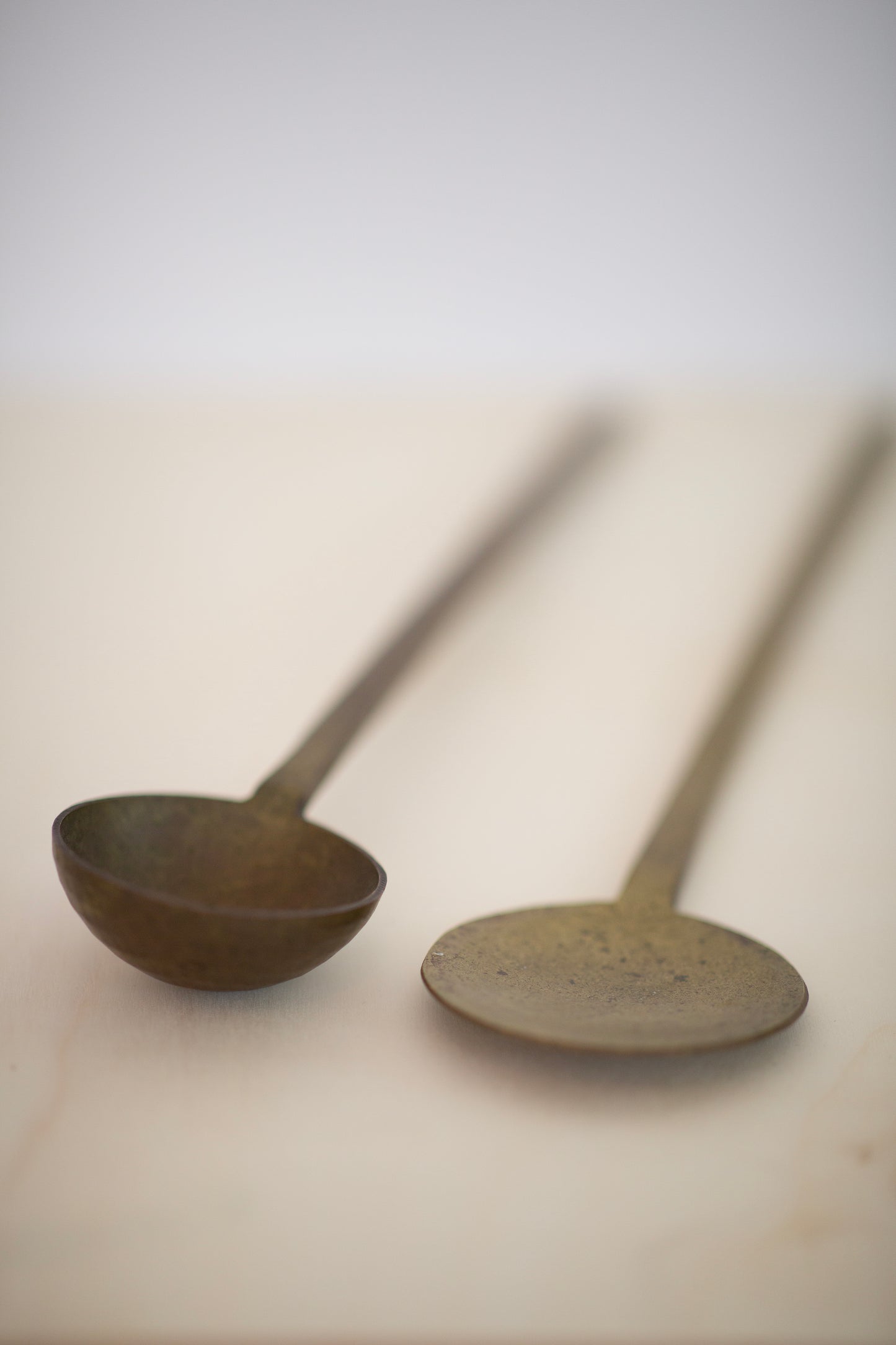 pair of large brass spoons
