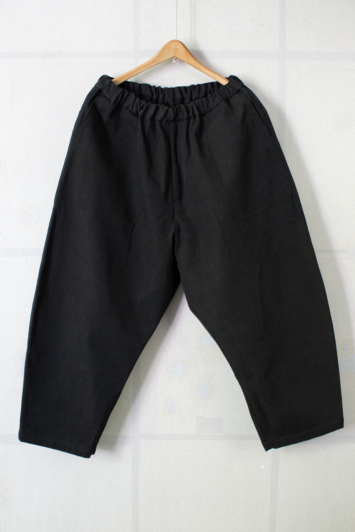 tapered pants in black/green wool-cotton twill