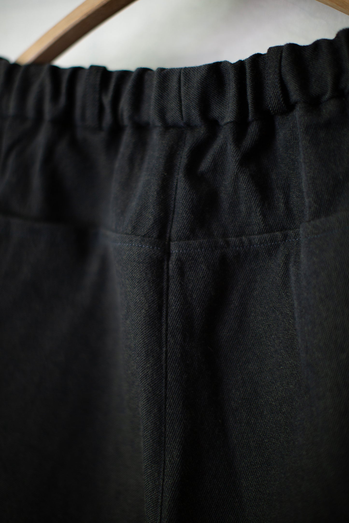 tapered pants in black/green wool-cotton twill