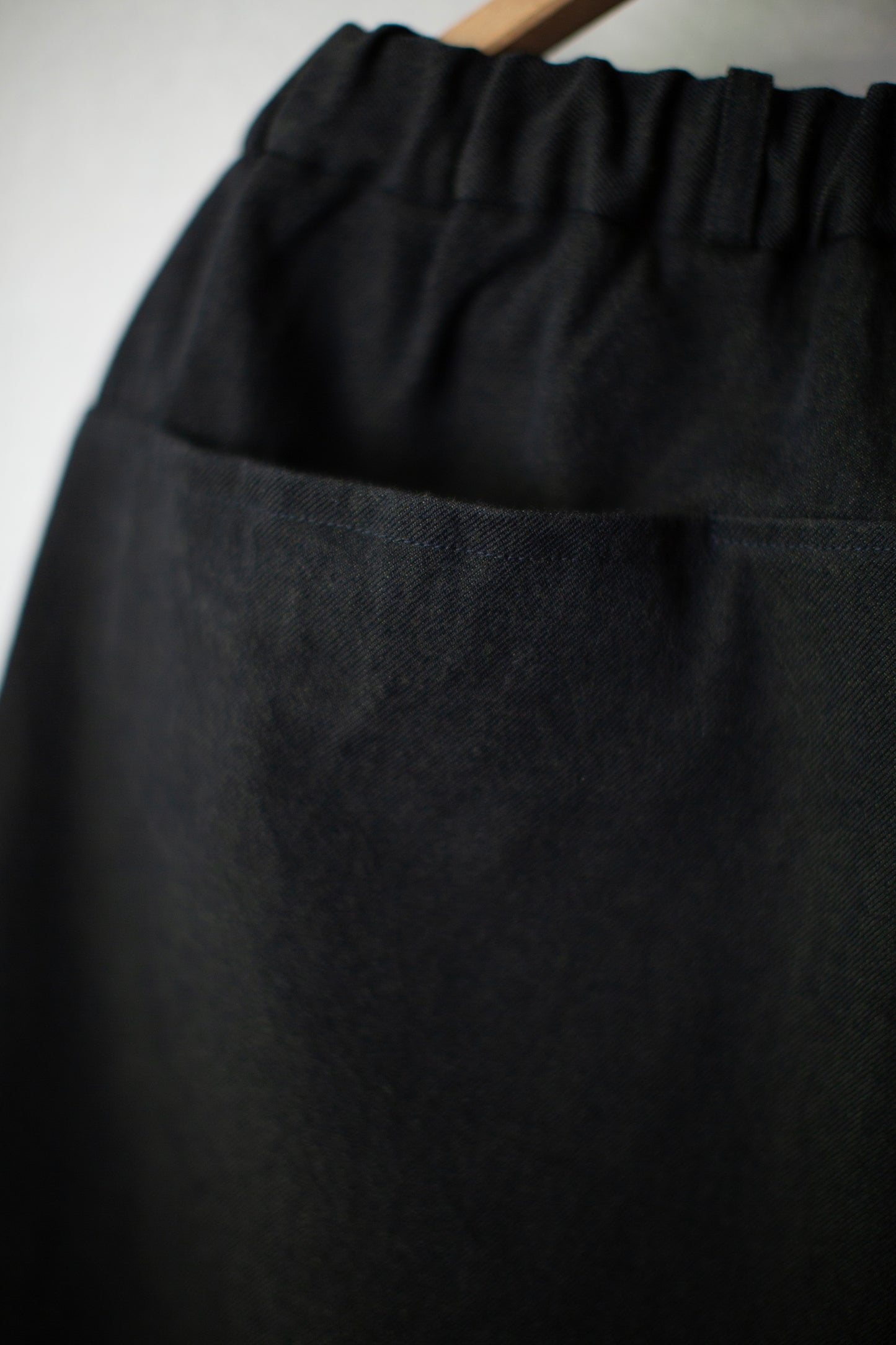 tapered pants in black/green wool-cotton twill