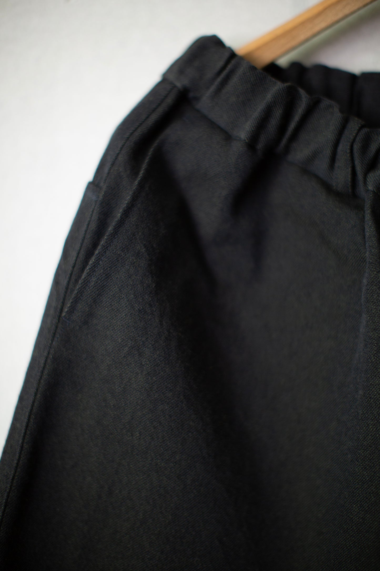 tapered pants in black/green wool-cotton twill