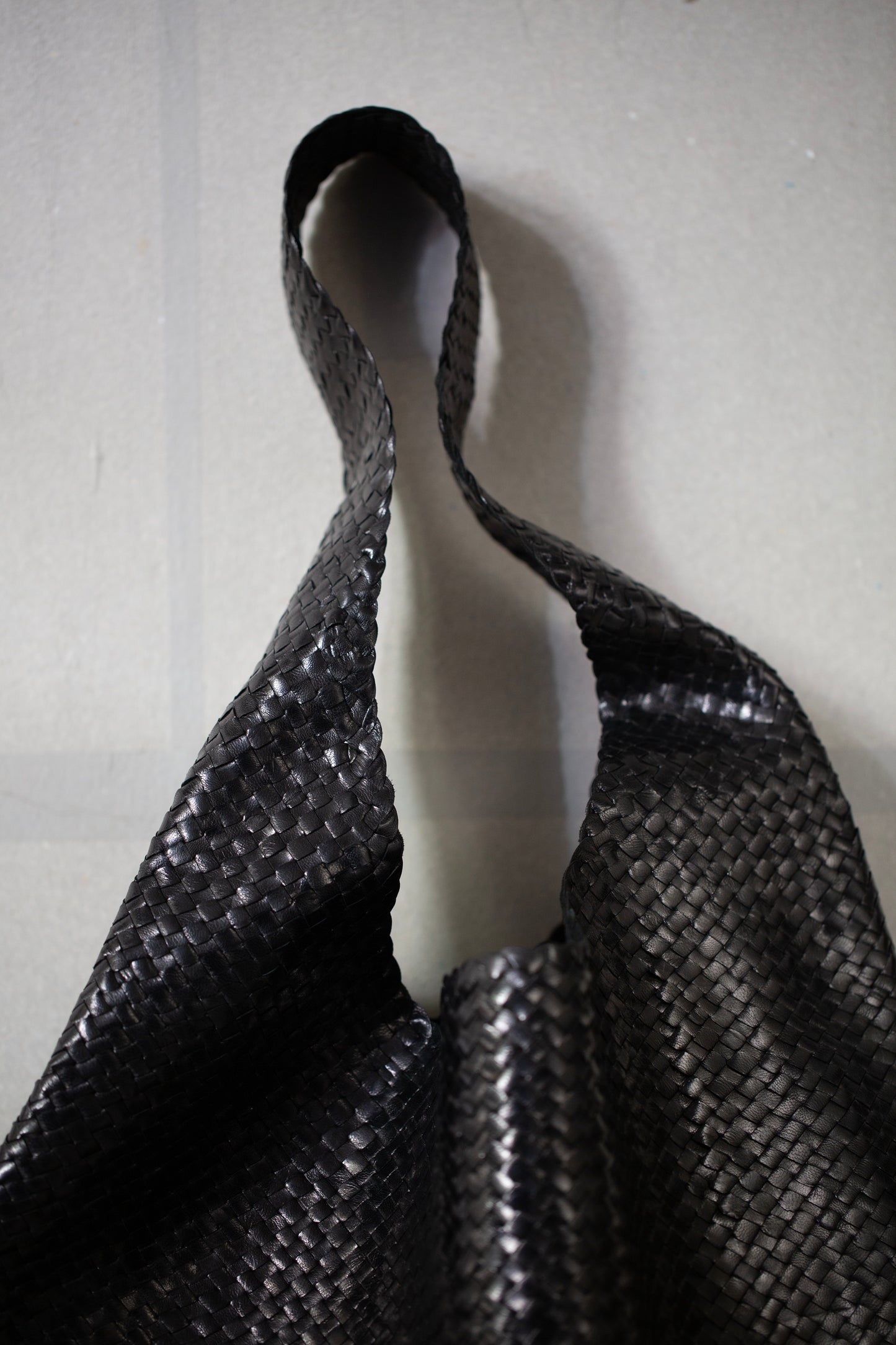 Seamless hand woven black carrier bag in goat leather