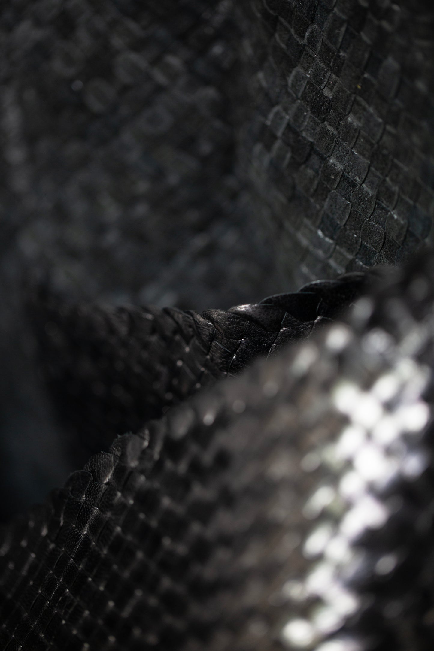 Seamless hand woven black carrier bag in goat leather