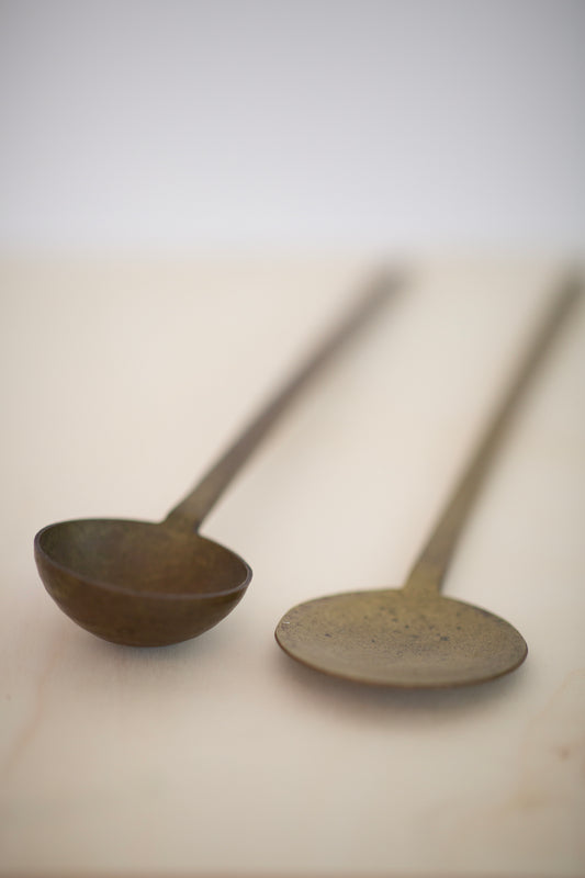 pair of large brass spoons